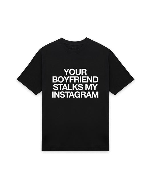 Black oversized t-shirt with YOUR BOYFRIEND STALKS MY INSTAGRAM printed in Helvetica across the chest, AS Colour Heavy Tee 5080.