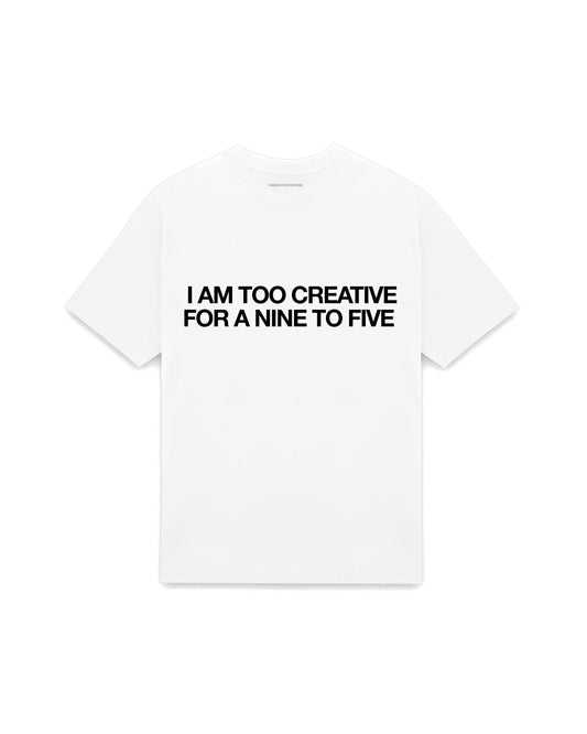 White oversized t-shirt with I AM TOO CREATIVE FOR A NINE TO FIVE printed in Helvetica across the chest, AS Colour Heavy Tee 5080.
