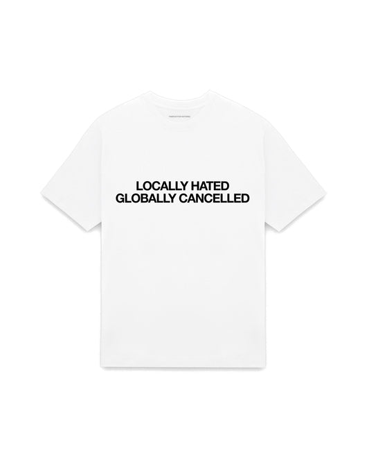 White oversized t-shirt with LOCALLY HATED GLOBALLY CANCELLED printed in Helvetica across the chest, AS Colour Heavy Tee 5080.
