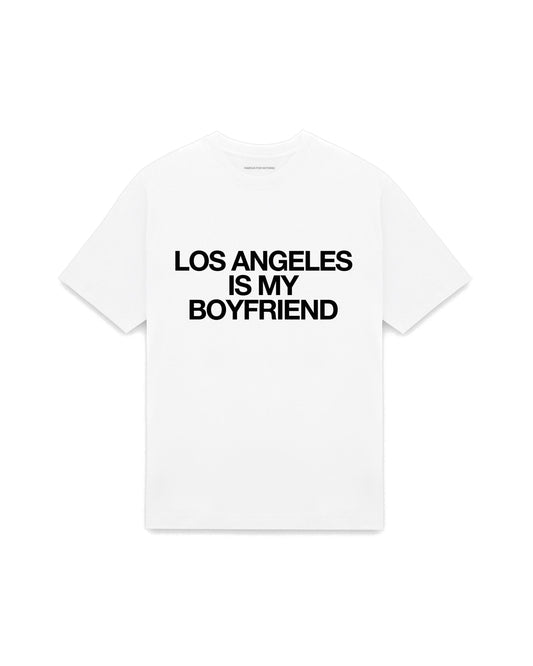 White oversized t-shirt with LOS ANGELES IS MY BOYFRIEND printed in Helvetica across the chest, AS Colour Heavy Tee 5080.
