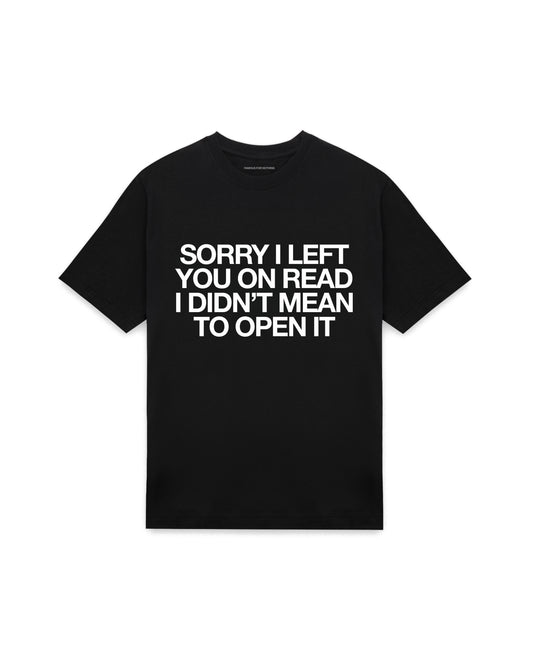 Black oversized t-shirt with SORRY I LEFT YOU ON READ I DIDN'T MEAN TO OPEN IT printed in Helvetica across the chest, AS Colour Heavy Tee 5080.