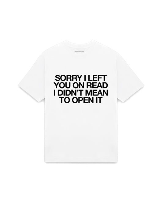 White oversized t-shirt with SORRY I LEFT YOU ON READ I DIDN'T MEAN TO OPEN IT printed in Helvetica across the chest, AS Colour Heavy Tee 5080.