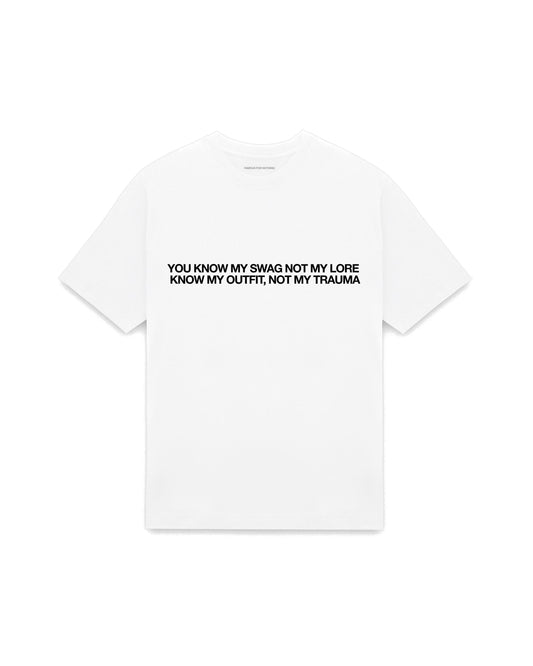 White oversized t-shirt with YOU KNOW MY SWAG NOT MY LORE, KNOW MY OUTFIT NOT MY TRAUMA printed in Helvetica across the chest, AS Colour Heavy Tee 5080.