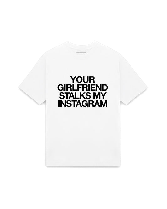 White oversized t-shirt with YOUR GIRLFRIEND STALKS MY INSTAGRAM printed in Helvetica across the chest, AS Colour Heavy Tee 5080.
